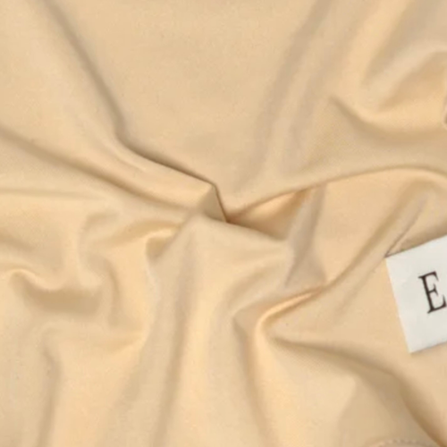 Gros plan sur la matière fluide de L'Étole ESMIA en coloris Aurore, hijab beige nude
